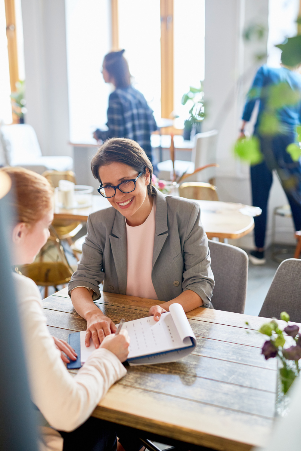 People collaborating together at a table in a modern office environment